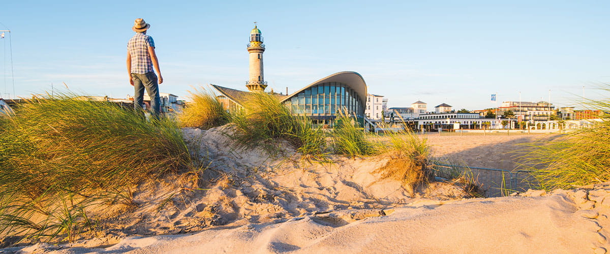 A man standing on the beach front of Warnemünde, Germany